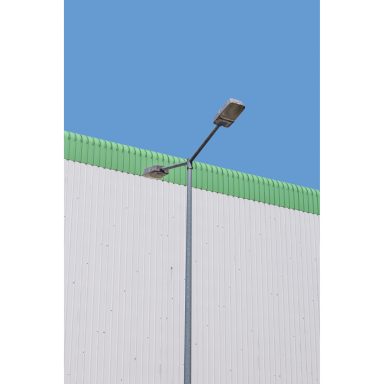 minimalistische Fotografie einer Laterne vor einer Halle